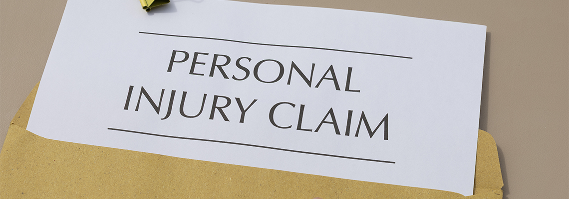 Personal Injury Claim and Money on Wooden Desk on Table