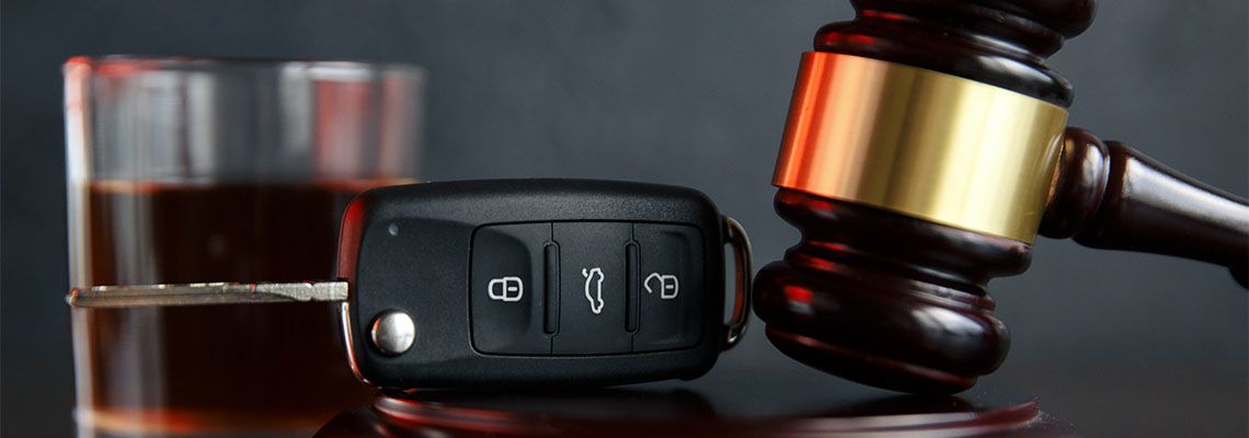 Car keys, gavel and glass of alcohol