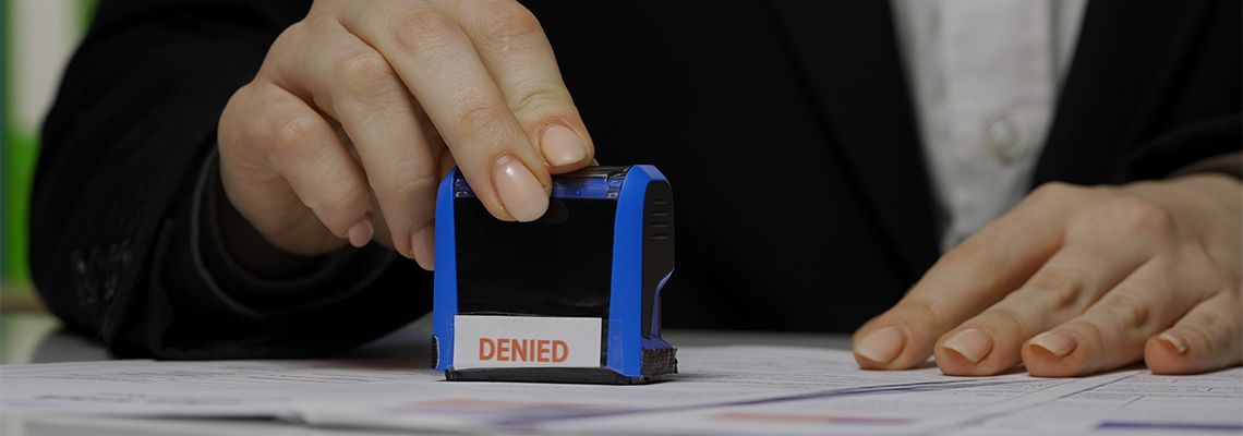 Women putting denied stamp in form