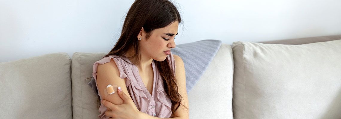 Women in pain after vaccination