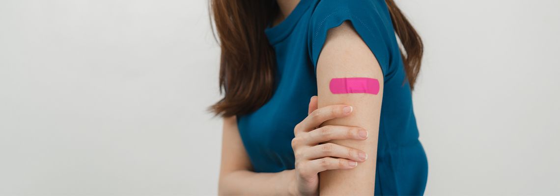 Women holding hand in pain after vaccination
