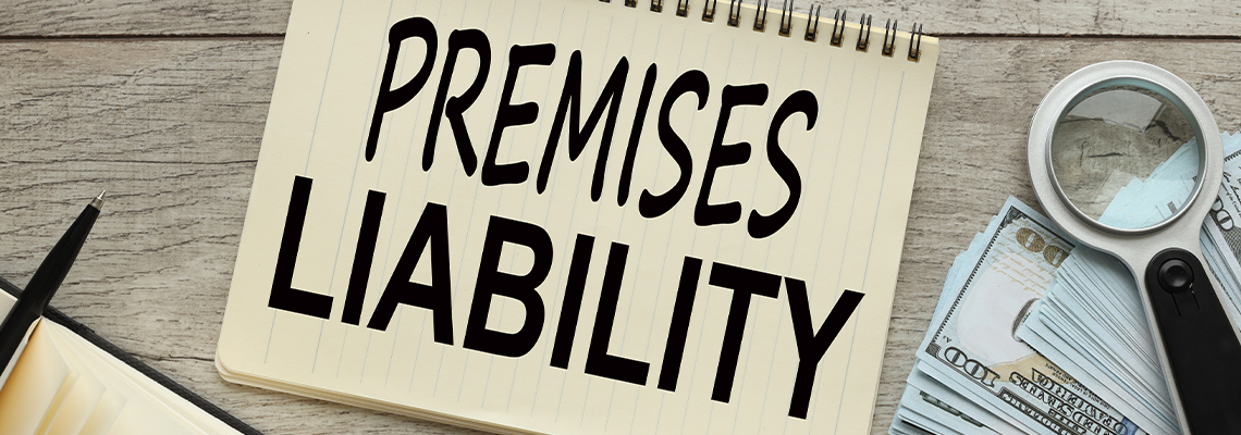 Premises liability work desk with notepad. bills of money and a magnifying glass