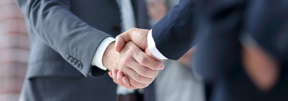Businessmen shaking hands after reaching agreement