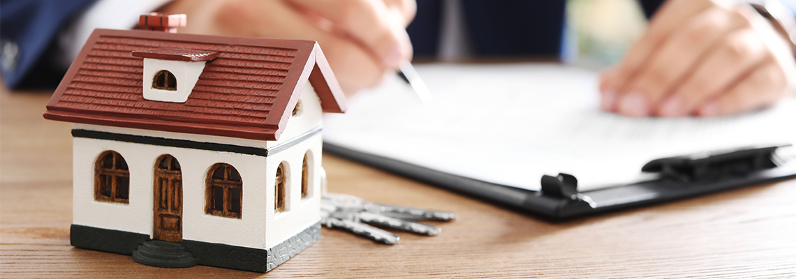 House Model and Blurred Lawyer on Background