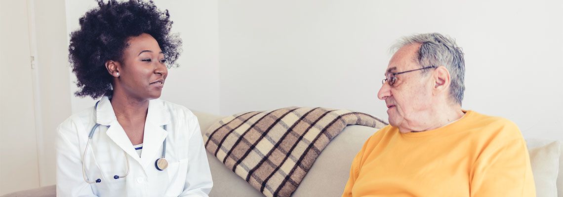 Doctor looking after senior old man