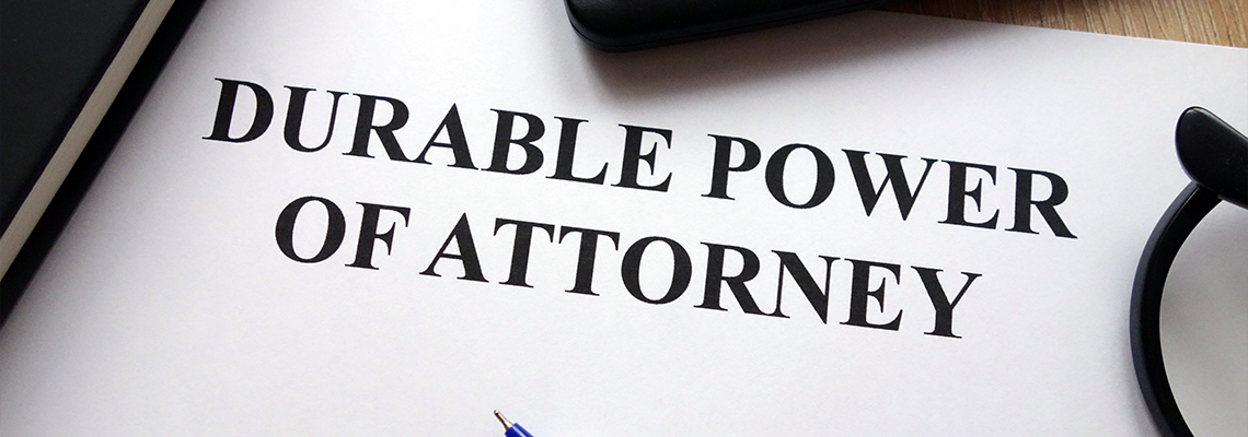 Durable power of attorney document, pen, glasses and calculator