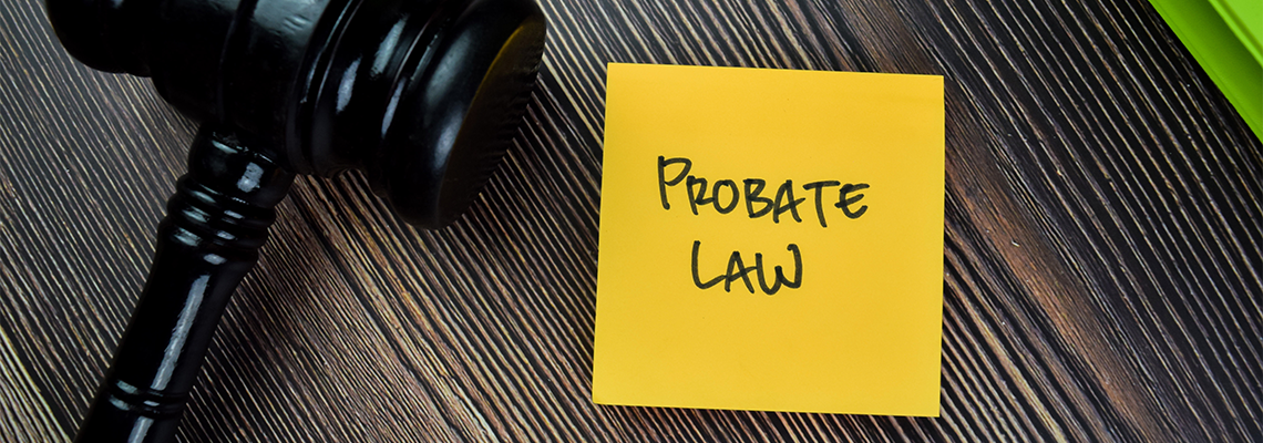 Concept of Probate Law write on sticky notes with gavel isolated on Wooden Table