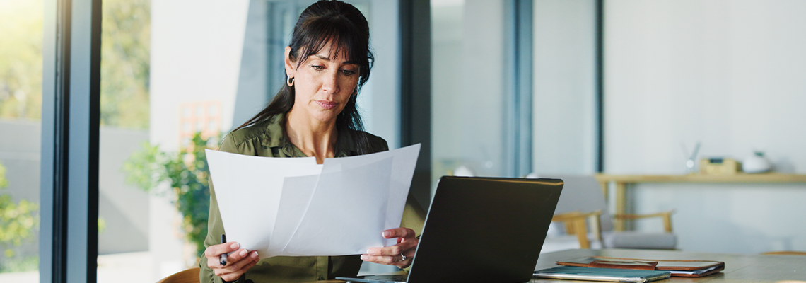 Business, woman and document with laptop at house for real estate