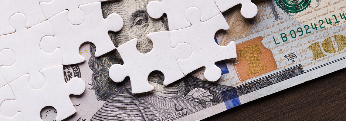 American dollar hidden under puzzle pieces