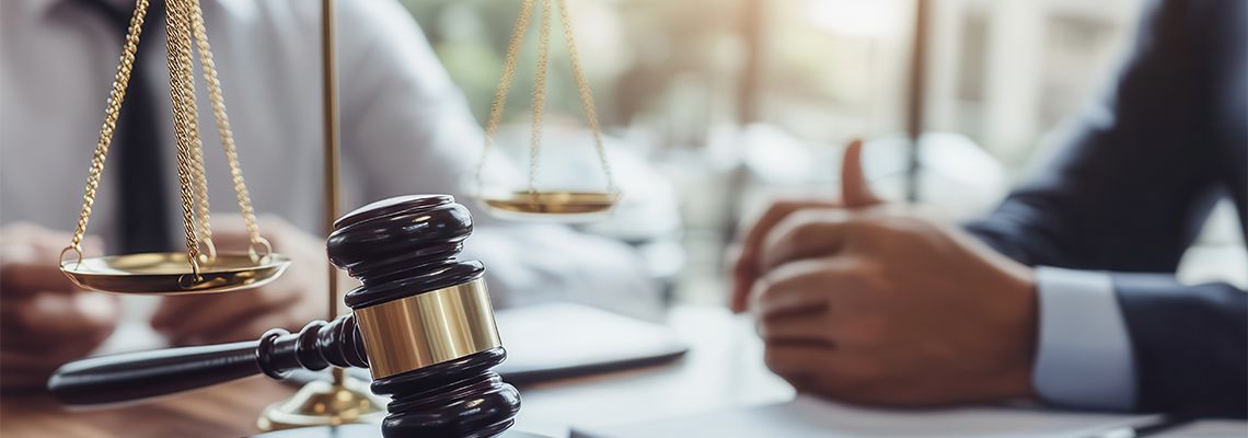 Gavel with client and attorney session in background