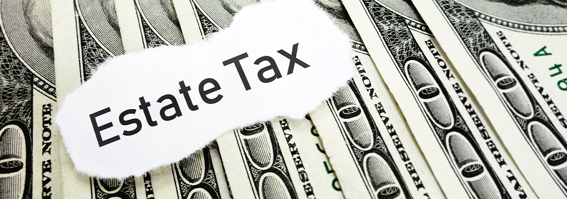 Estate Tax on Paper over Stack of Dollar Bills