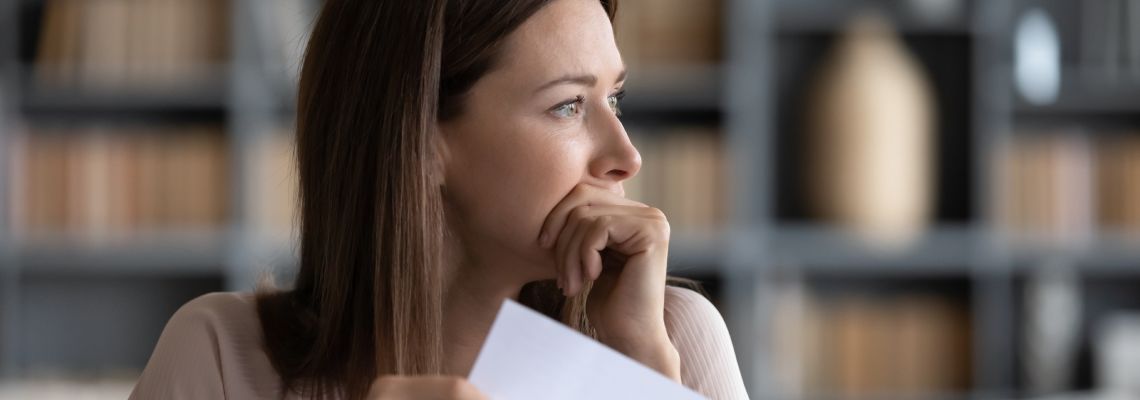 Stressed women holding creditors demand letter