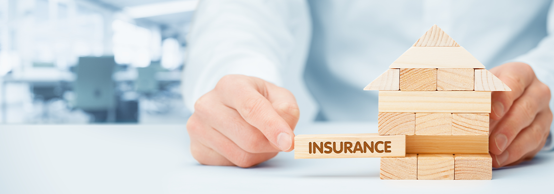 Property insurance wooden block on table