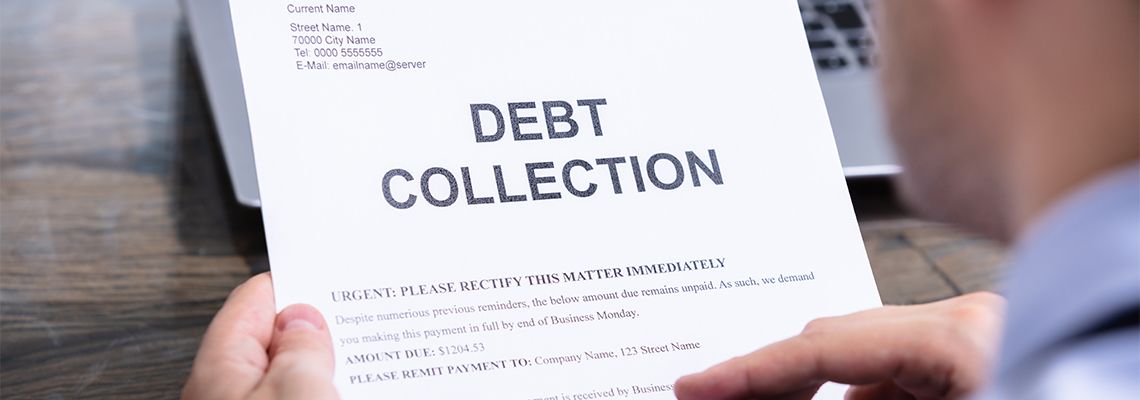 Man Reading Debt Collection Letter