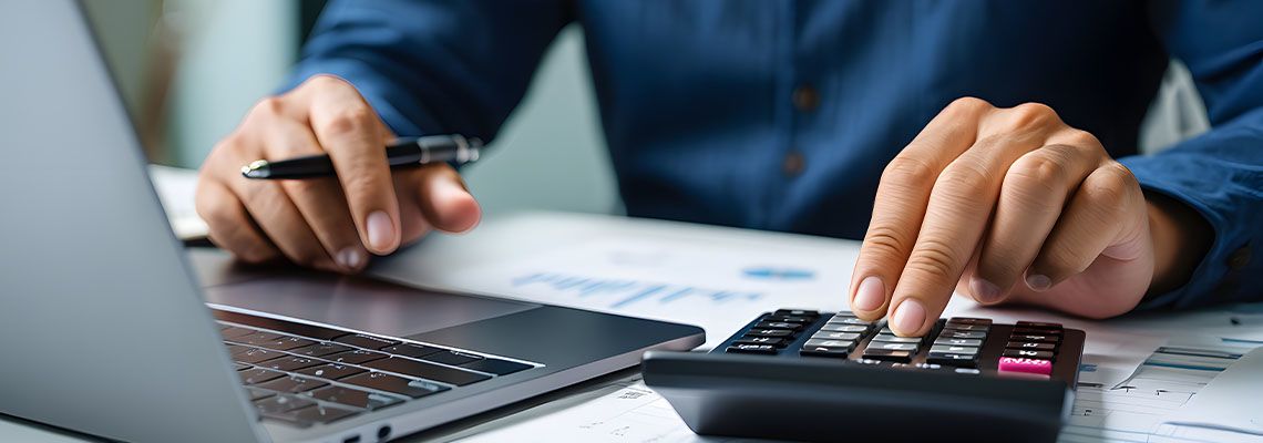 Businessman using calculator for tax calculation
