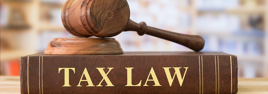 Tax law book and gavel on top of it