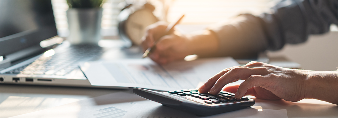 Tax deduction planning concept. Businessman calculating business balance