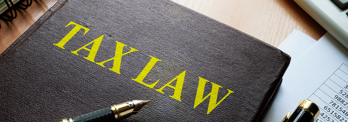 Tax law book and pen on a table