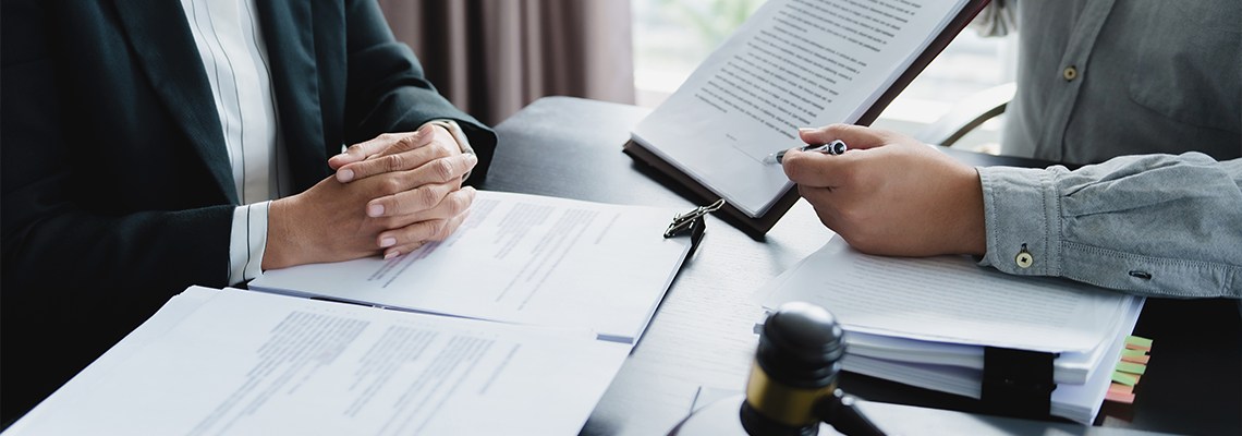Lawyer signing legal document with Judges gavel
