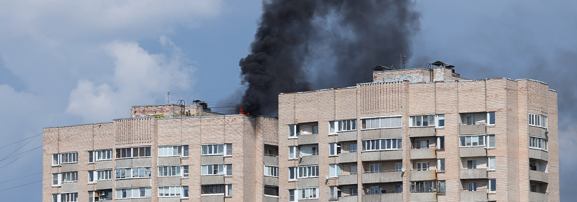 A small fire on the roof of a high-rise apartment building