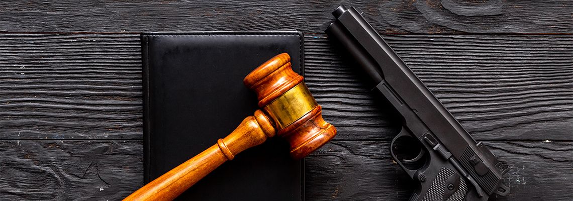 Gun and gavel on table
