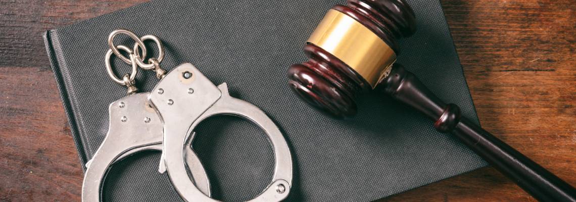 Gavel and Handcuff on table