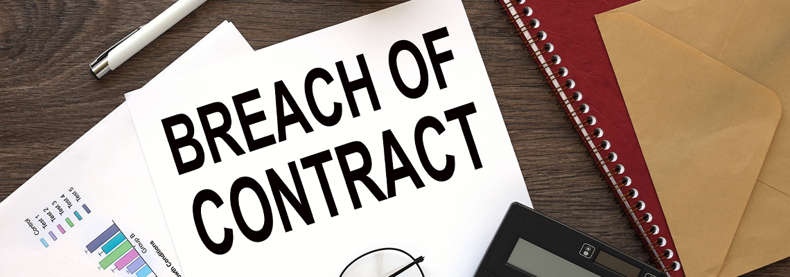 Breach of contract on the work desk there is a red notepad and an envelope