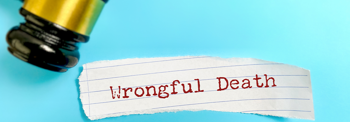 Close up of wrongful death text with judge gavel on blue background