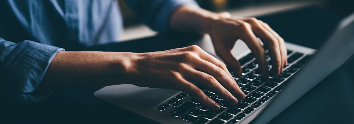 Close up of hand working on laptop