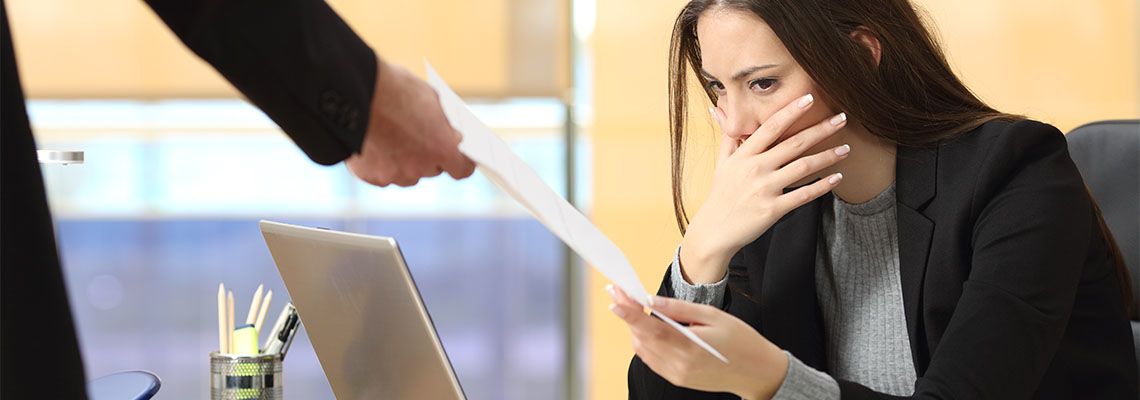 Boss hands women termination letter in office