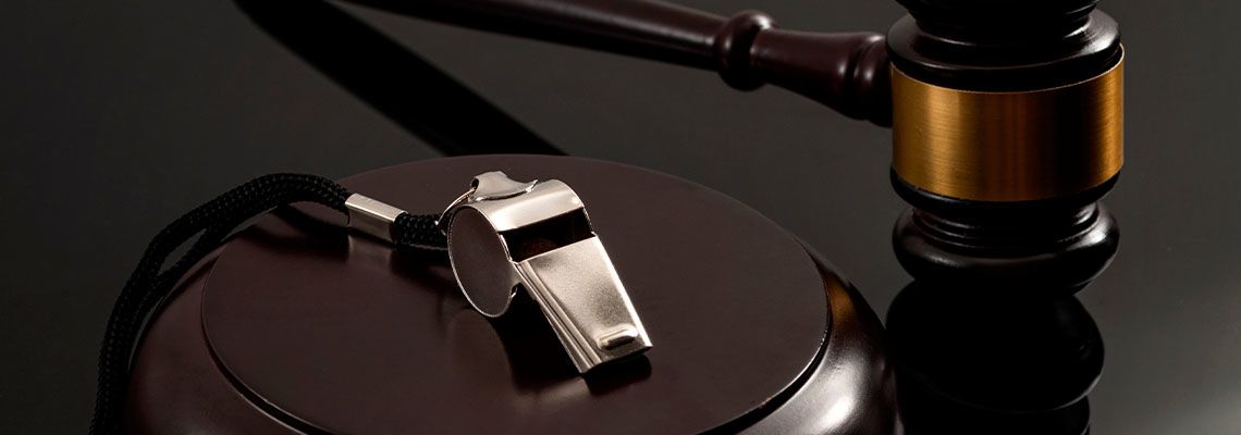 Whistle and Gavel in table representing whistleblower law