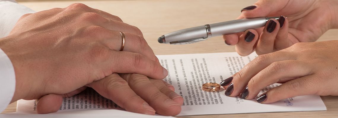 Wife and husband signing divorce documents