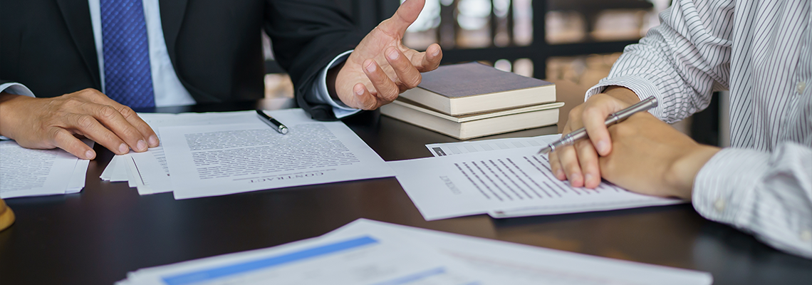 Lawyer Legal counsel presents to the client a signed contract with gavel and legal law