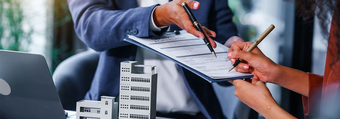 Real Estate agent and client signing commercial property deal