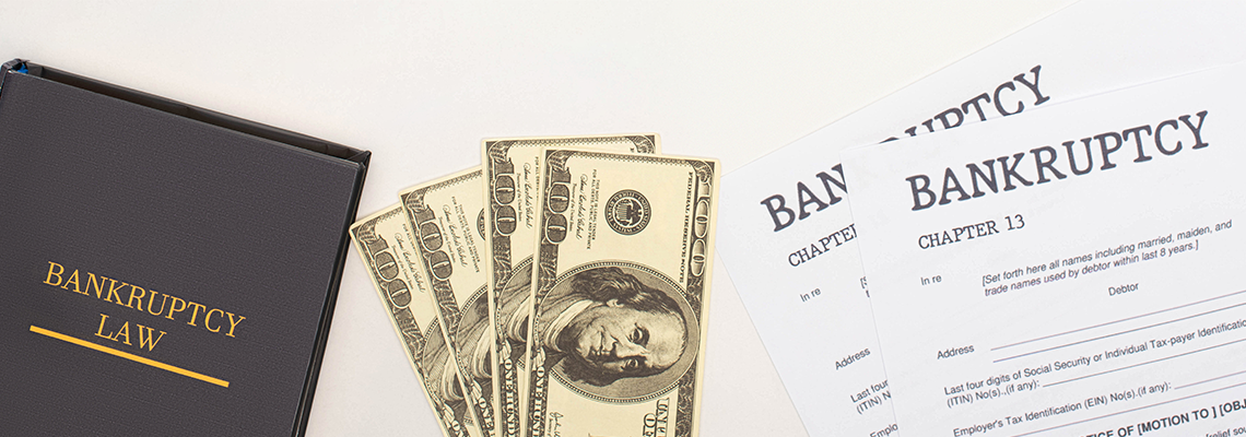Bankruptcy Papers, Law Book and Money on White Background