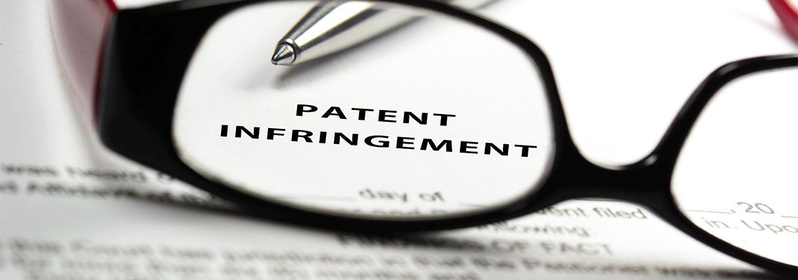 Patent infringement word seen through reading glasses