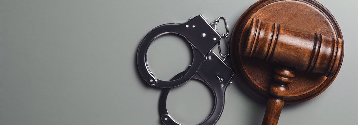 Gavel and Handcuff in table