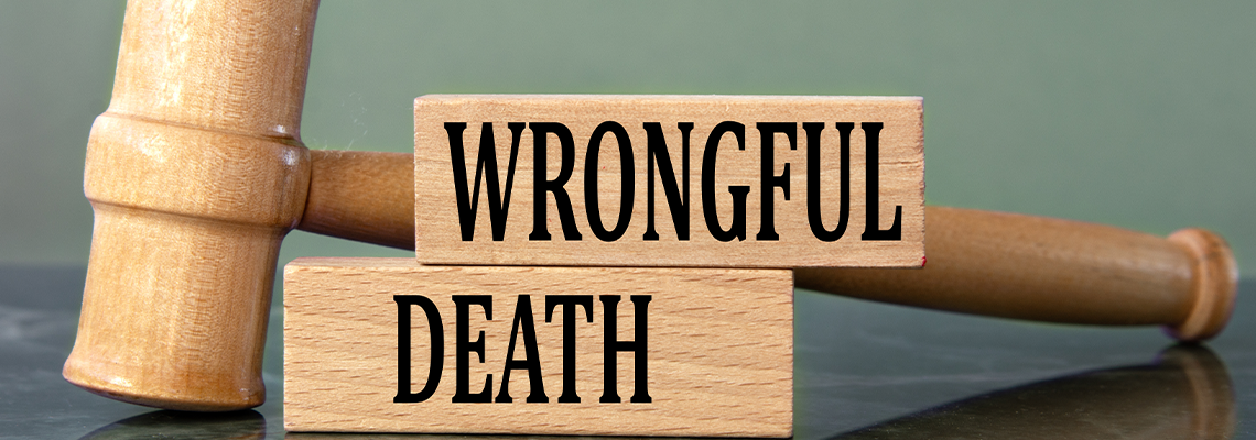WRONGFUL DEATH - words on wooden blocks with a judge's gavel in the background