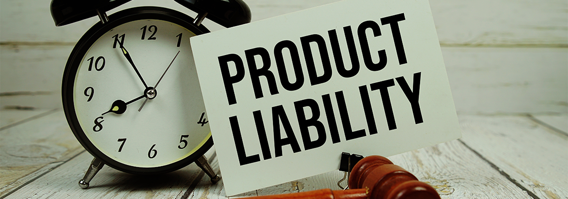 Product Liability text on paper card with alarm clock and wooden judge gavel