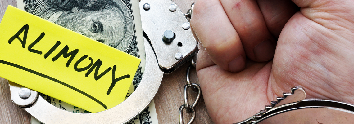 Alimony and hand in handcuffs