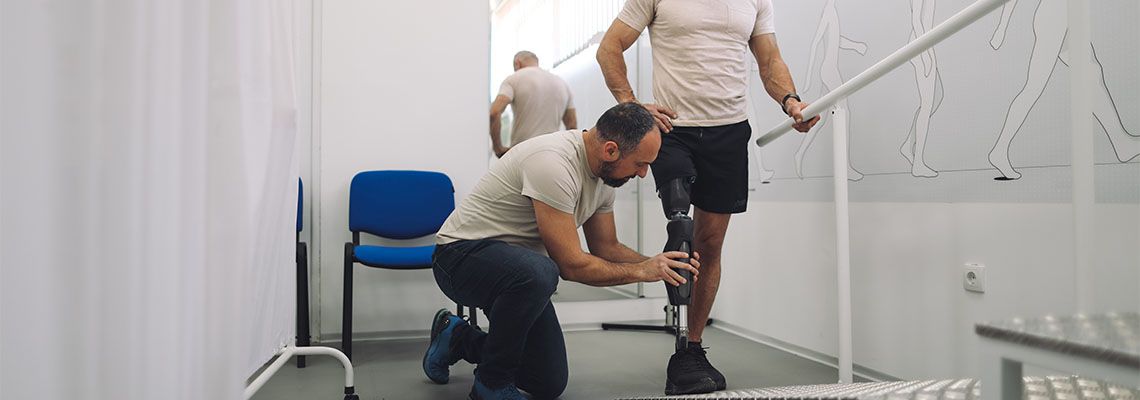 Rehabilitation specialist assisting man with prosthetic leg