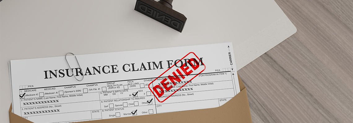 Document with denied stamp and a stamper put on the wooden table