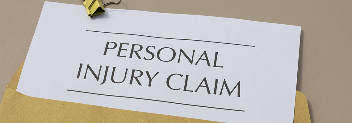 Personal Injury Claim and Money on Wooden Desk