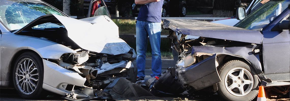 Man standing in a car accident site
