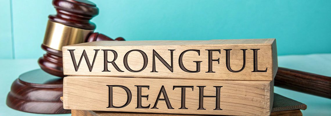 Wrongful Death word in wooden cubes with gavel in table
