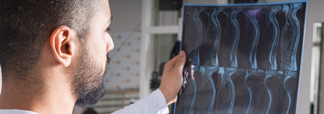 Doctor analysing X-ray image of spine in lab