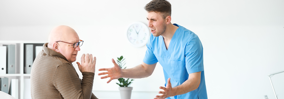 Medical worker mistreating senior man in nursing home