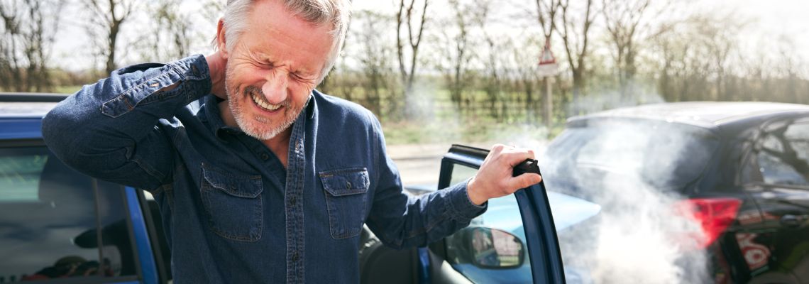Driver With Whiplash Injury Getting Out Of Car After Traffic Accident