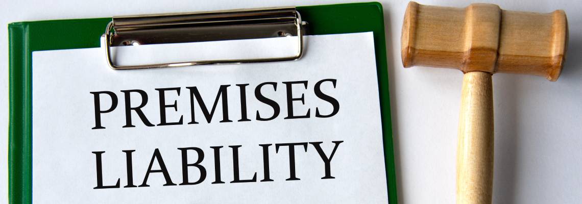 Premises Liability words on white sheet with gavel in table