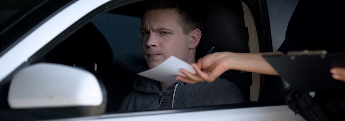 Police woman giving fine receipt to driver